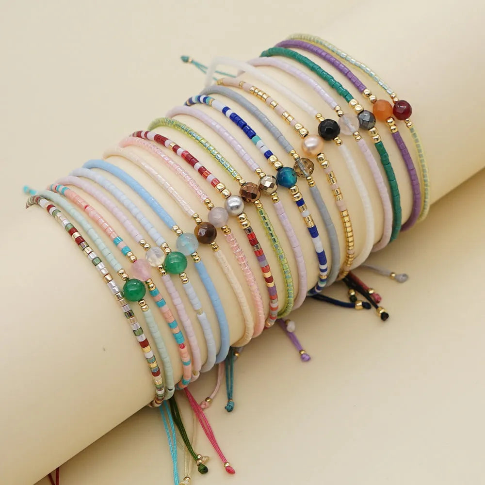 Handmade glass beaded bracelet with geometric design and semi-precious stone lucky bead charm