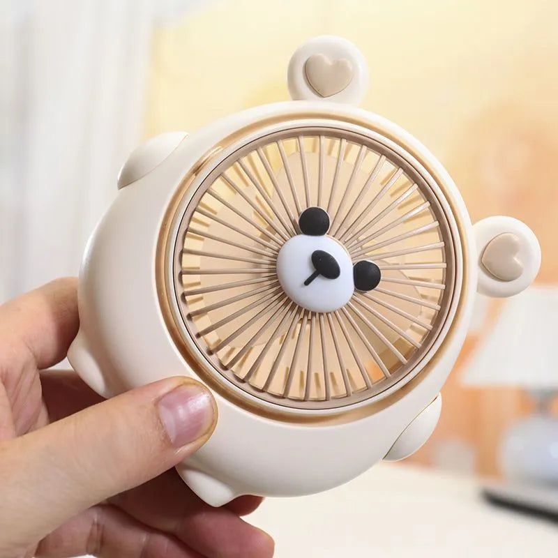 Cute dog-shaped USB desktop electric fan in a choice of colours including brown and pink, showing its plastic construction.