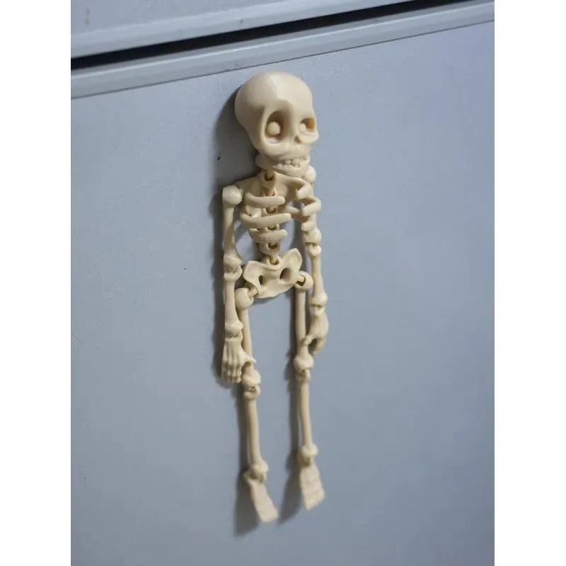 3D-printed PLA skull model Halloween fridge magnet ornament in luminous green colour.