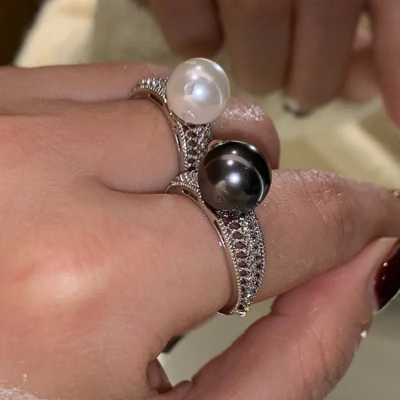 Adjustable geometric copper ring for women with a black pearl on an open band.