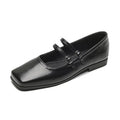 Women's silver leather Mary Jane flats with a cross buckle strap and round toe.