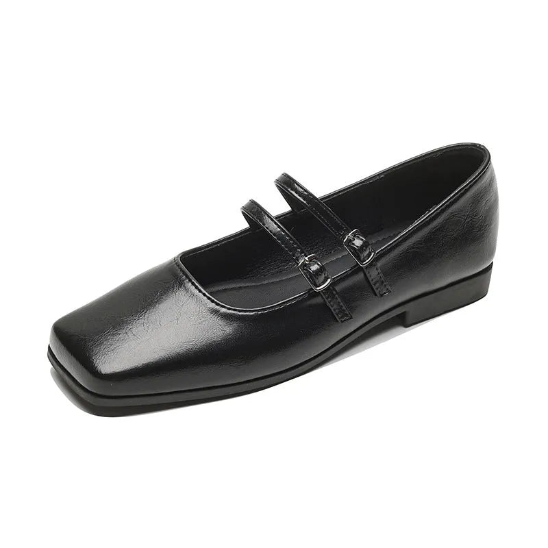 Women's silver leather Mary Jane flats with a cross buckle strap and round toe.