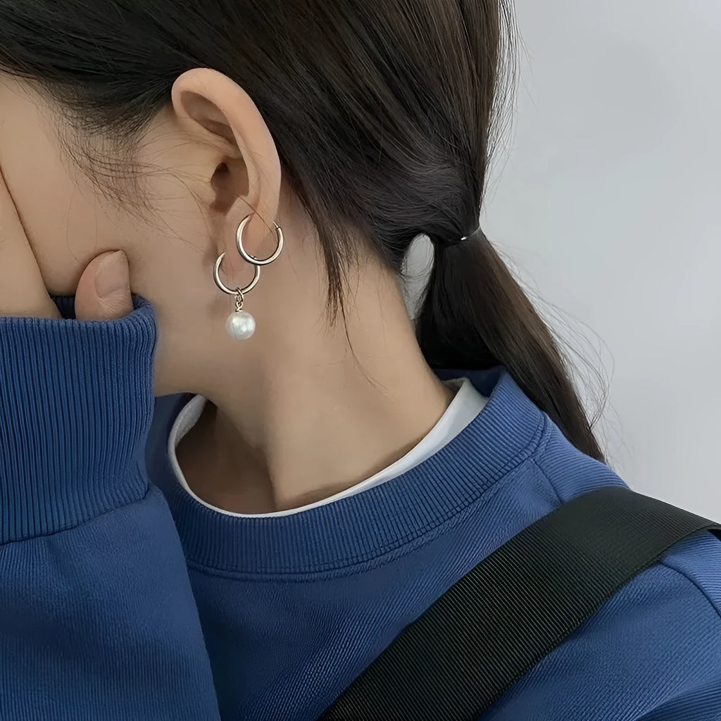 Geometric pearl drop earrings with titanium steel alloy construction and round element accents