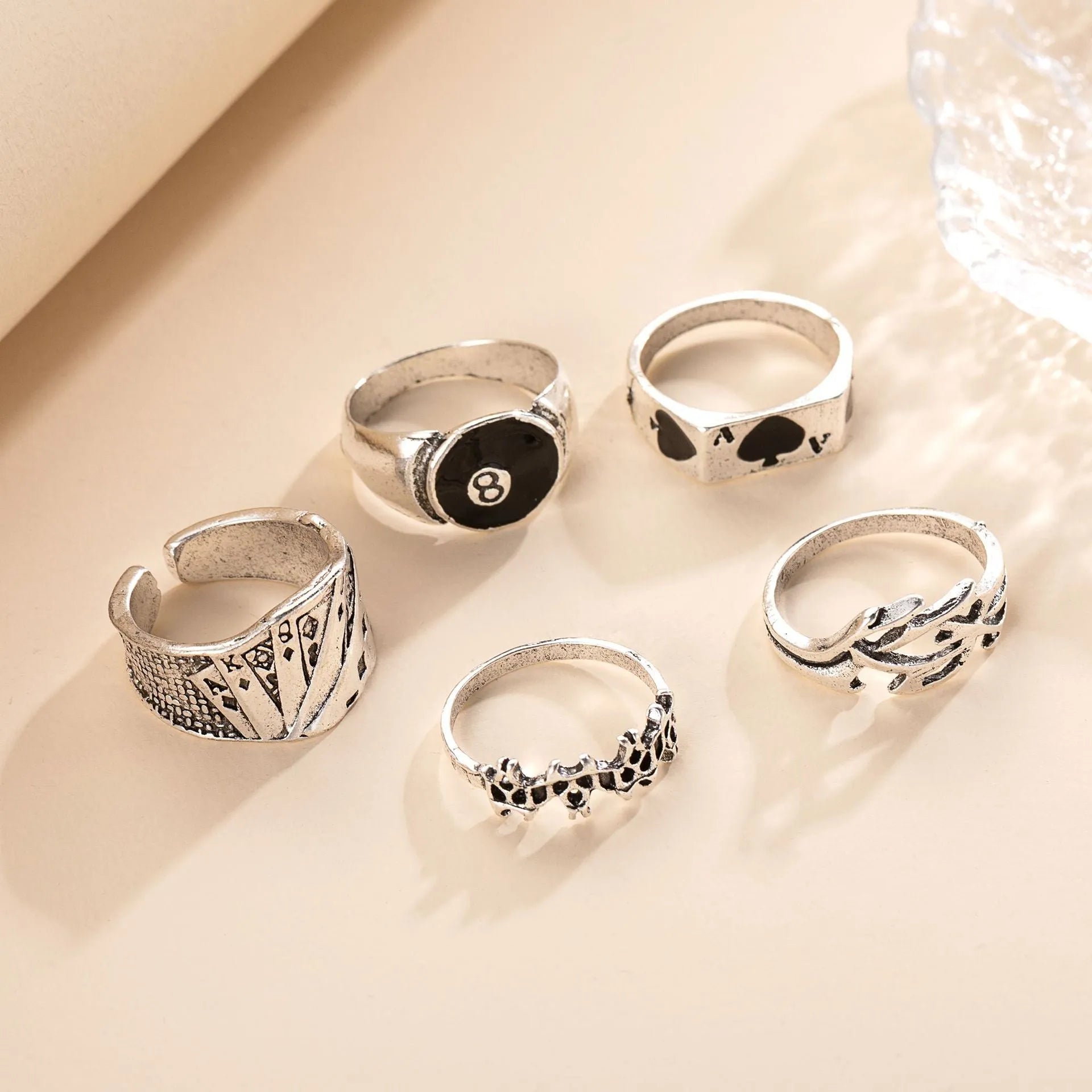 Black alloy ring with a detailed retro spade card poker design on a finger.