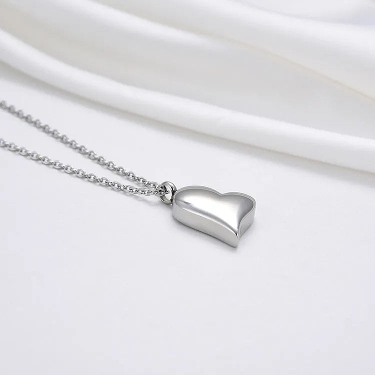 Silver curved peach heart pendant necklace on a chain with extension