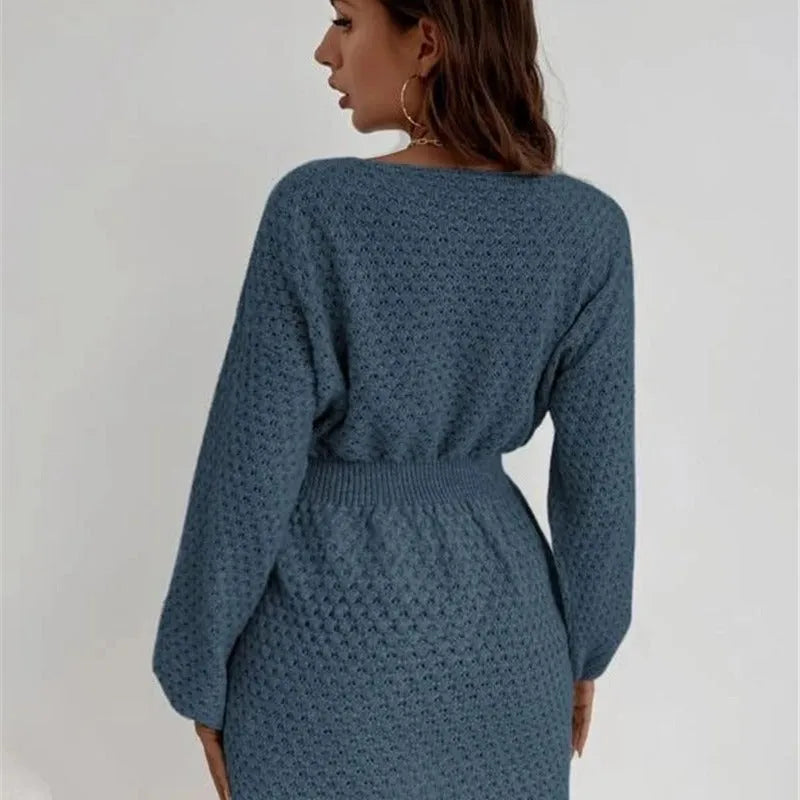 Blue women's knitted dress with crocheted flowers, round neck, and fitted waist.