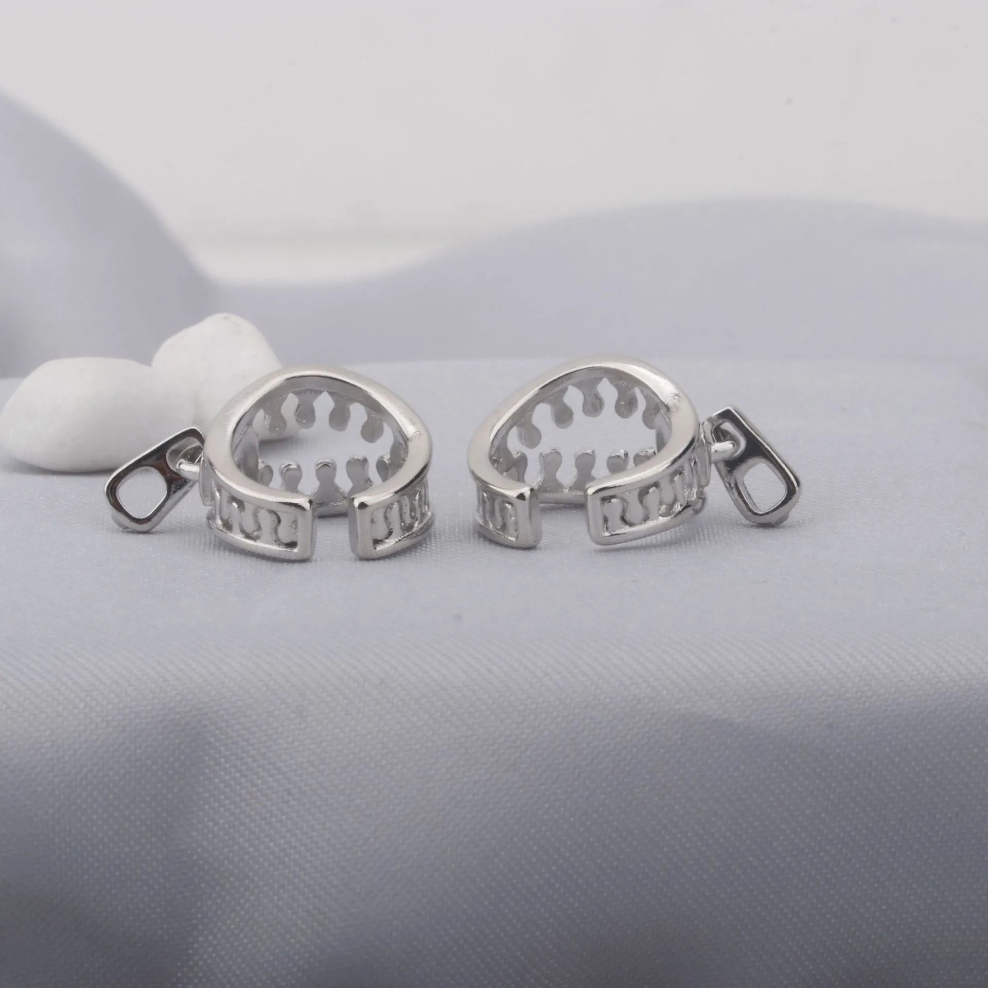 Geometric copper ear clips with zipper design showing 20-24mm bone shape