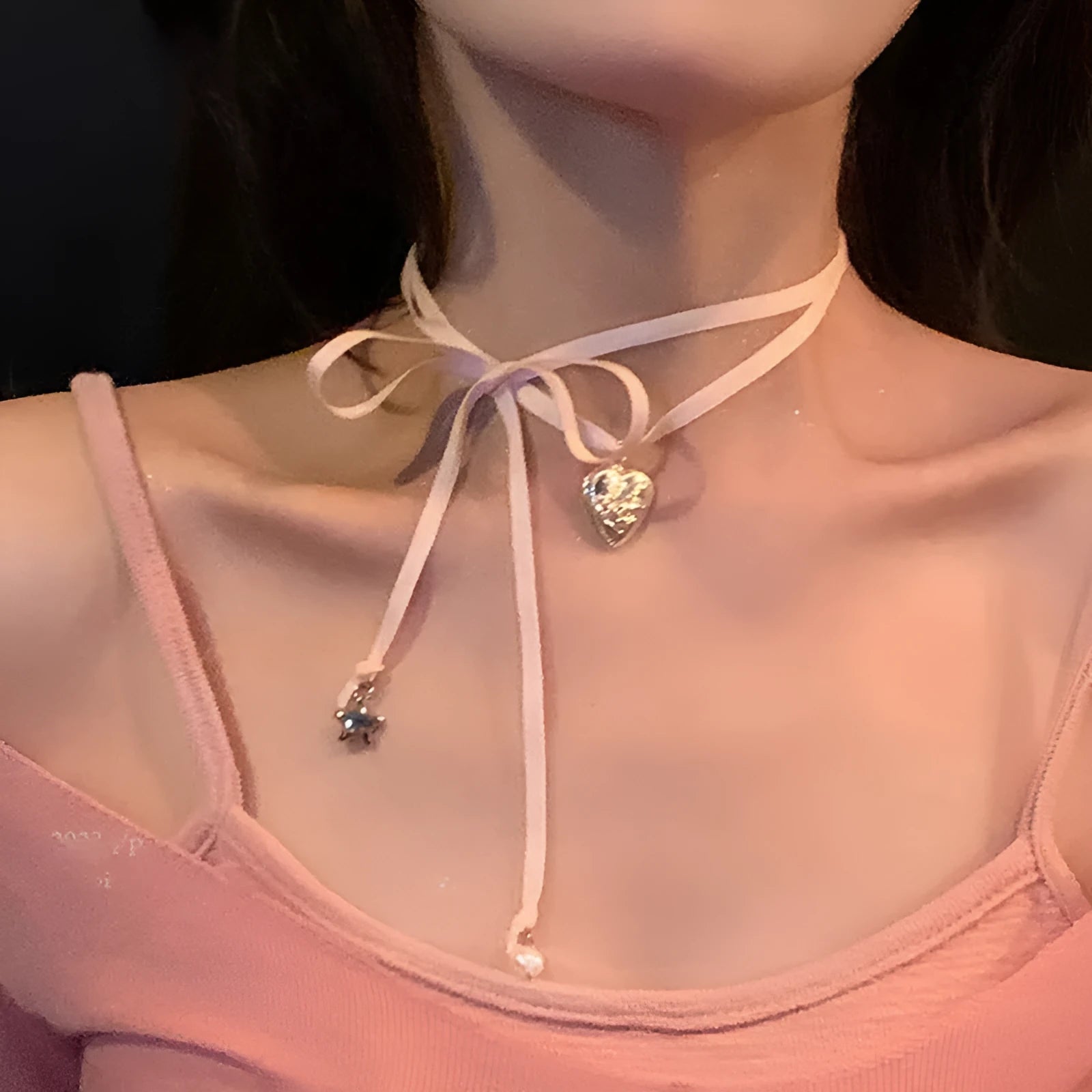 Women's alloy fashion necklace with a detailed ribbon and love pendant design on a clavicle chain, shown in one of 33 colour options.