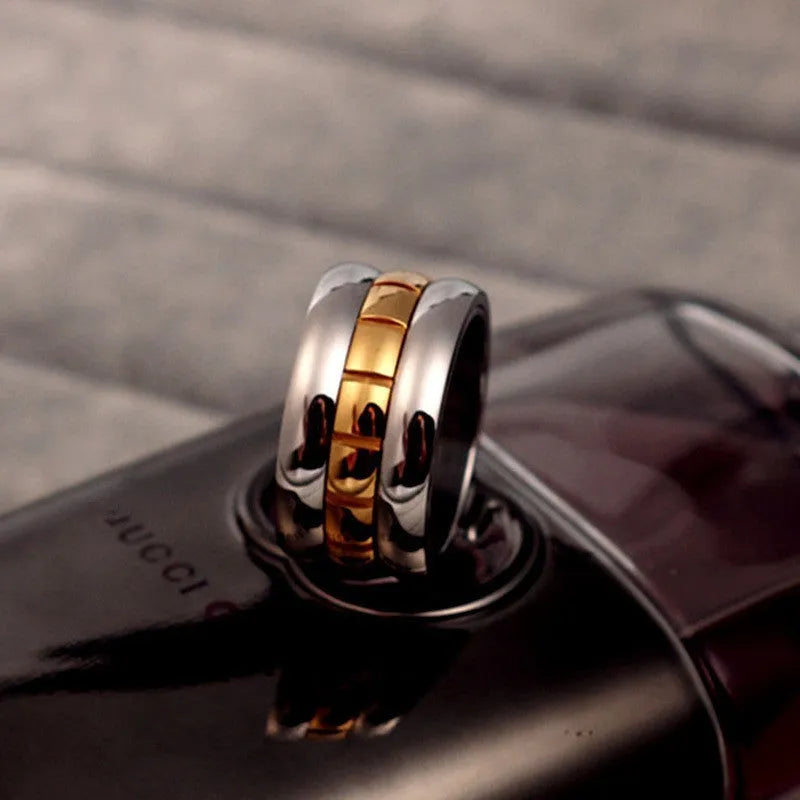 Gold titanium steel knuckle ring with ultra-wide band and rotating tail mechanism