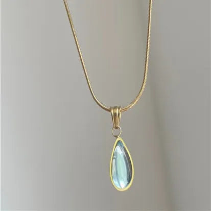 Retro titanium steel necklace with blue gemstone water drop pendant on a snake chain.