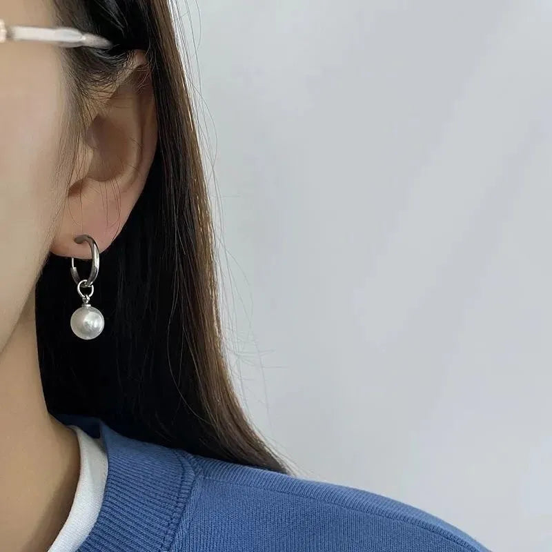 Geometric pearl drop earrings with titanium steel alloy construction and round element accents