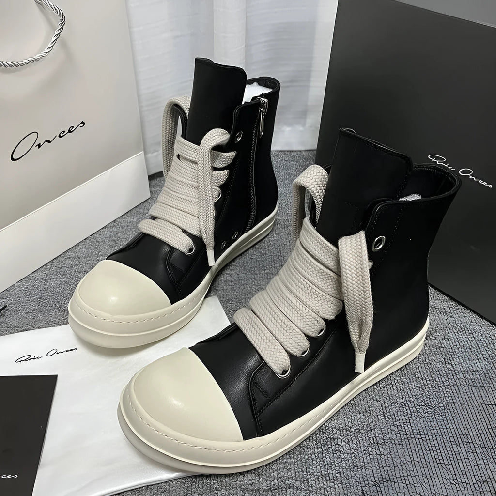 Men's and women's high-top leather sneakers in black with a side zipper and round toe on a rubber sole.