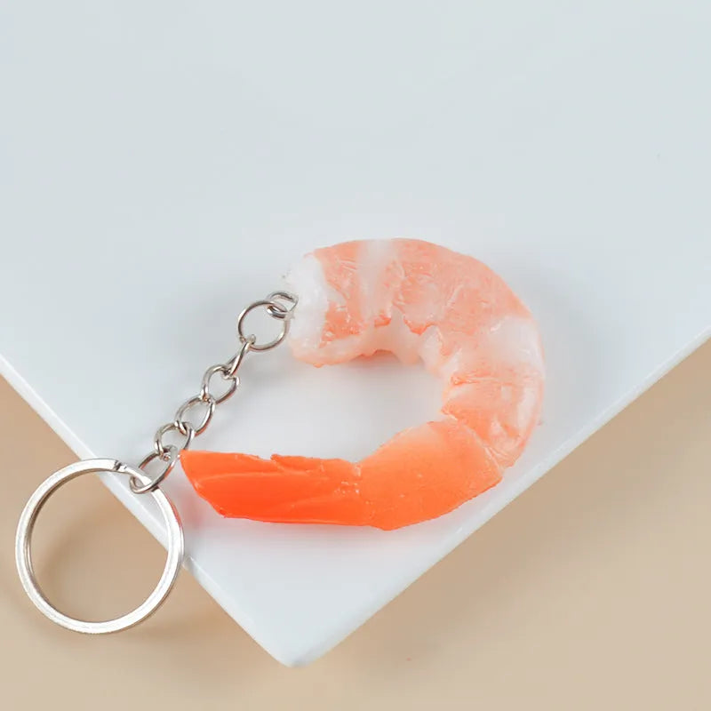 PVC injection moulded shrimp-shaped keychain with door buckle, 1.5cm thick, on a white background.