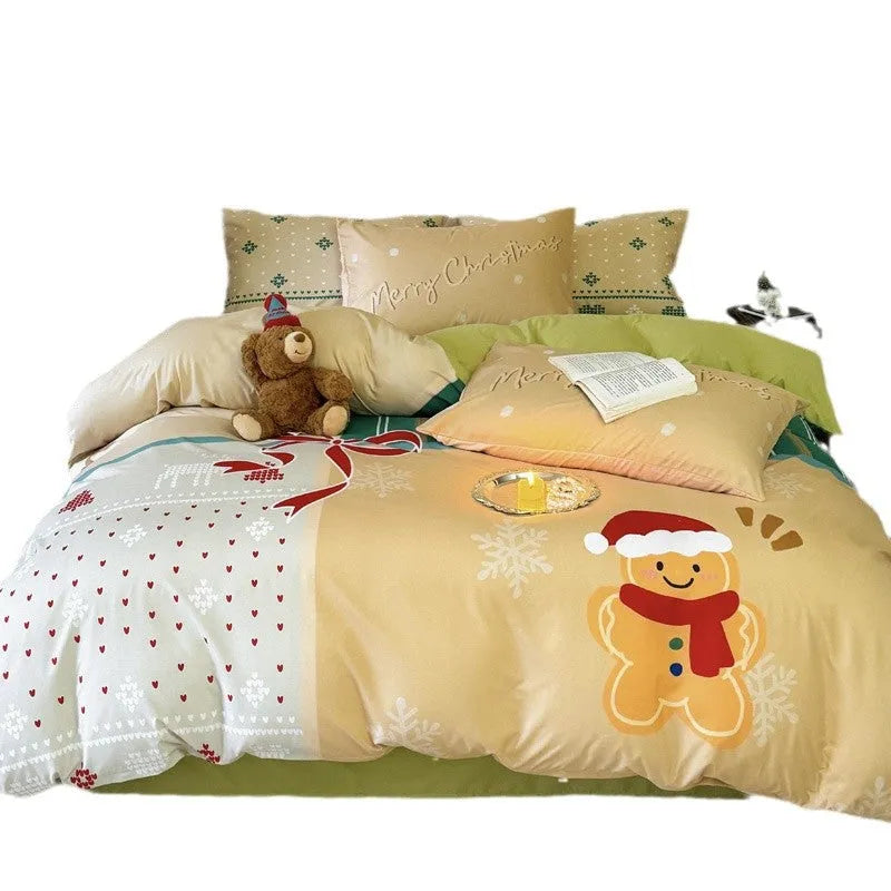 Christmas cartoon pattern four-piece bedding set with sheet, quilt cover, and two pillowcases on a bed.