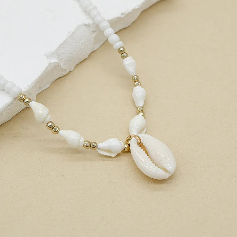 White Mother of Pearl conch shell pendant necklace on an electroplated chain.