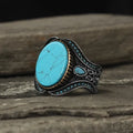 Men's turquoise alloy ring in antique silver colour showing round design and stone detail