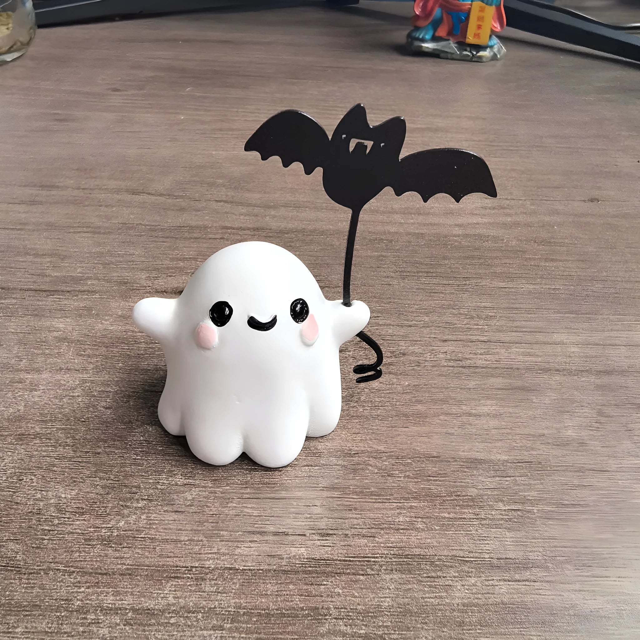 Mini resin statue of a ghost walking a dog and holding a bat, Halloween decoration.