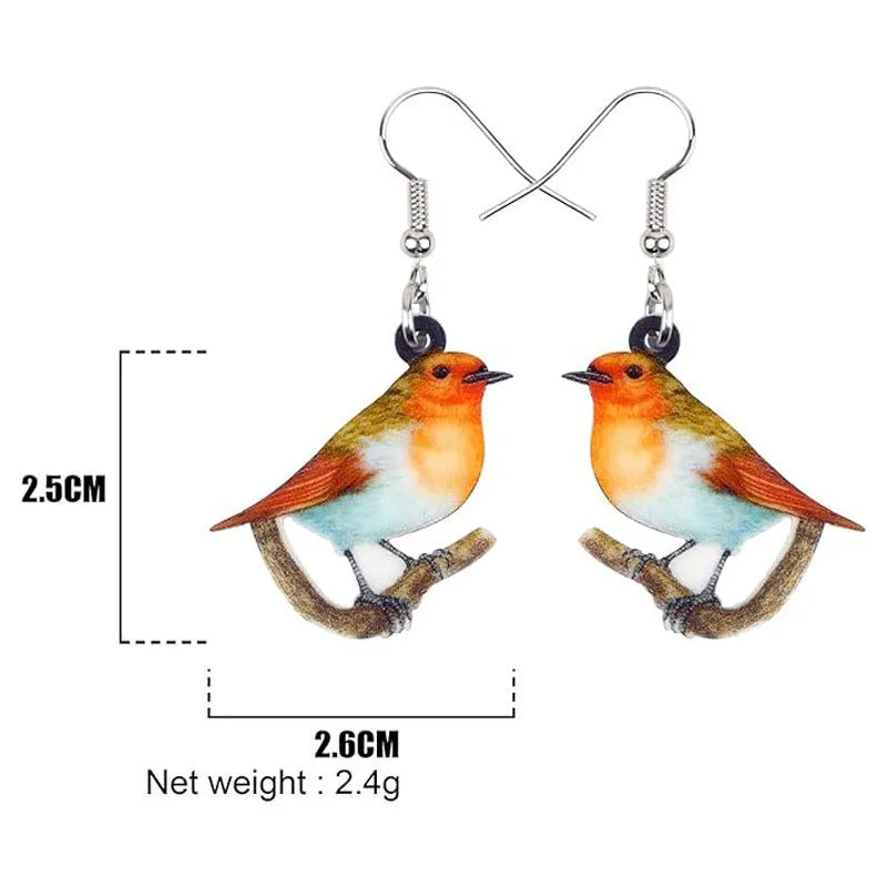 A pair of blue titmouse pendant earrings made from printed acrylic with a geometric, animal-inspired design.