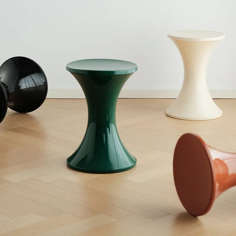 Plastic hourglass-shaped shoe changing stool shown in a selected colour.