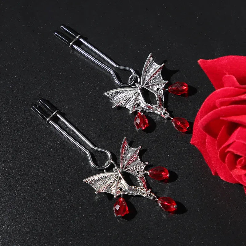 Silver bat nipple clamp with ruby detail and adjustable mechanism