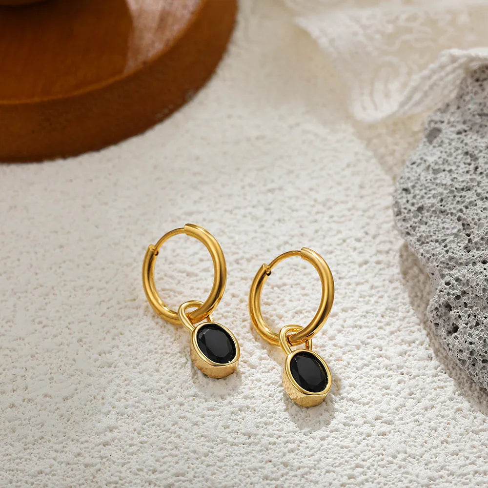Women's oval-shaped retro zircon earrings in copper, shown in emerald green colour.