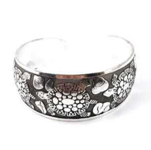 Open cuff bracelet with carved ethnic Miao silver design in alloy material