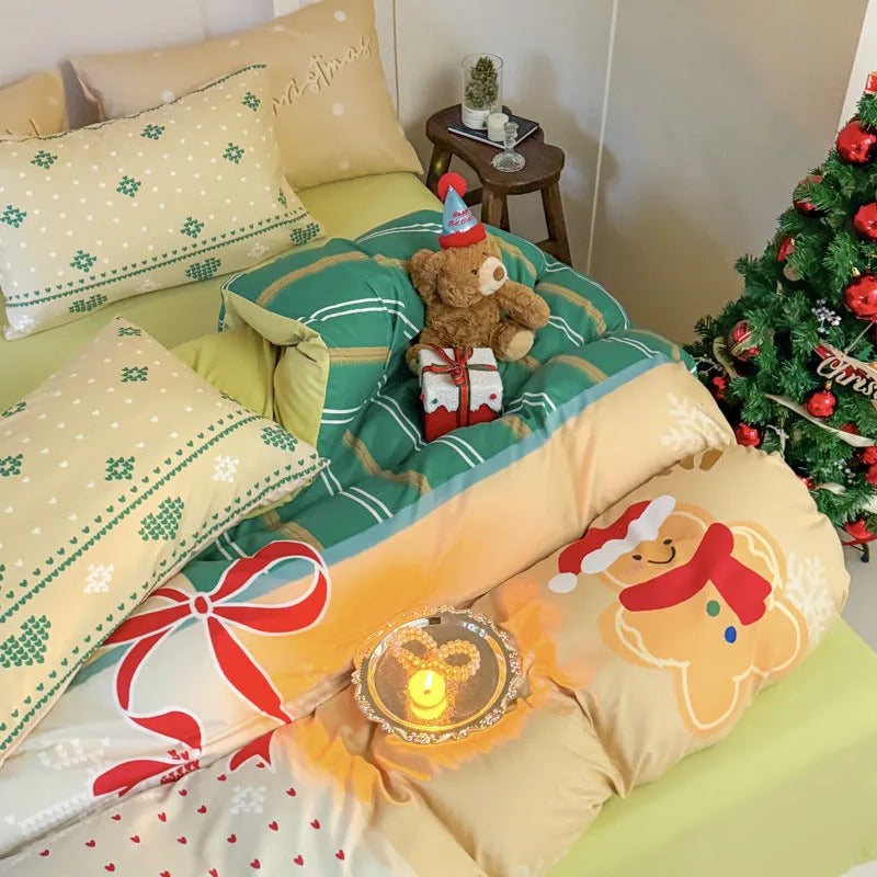 Christmas cartoon pattern four-piece bedding set with sheet, quilt cover, and two pillowcases on a bed.