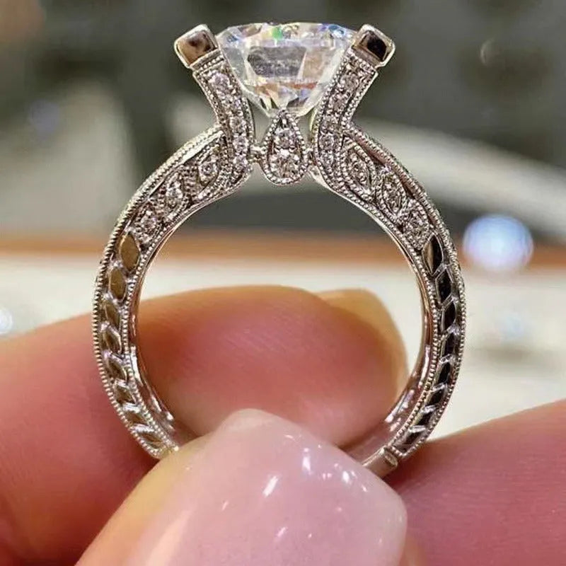 Geometric women's silver fashion ring with round details in gold or white electroplated finish on a finger.