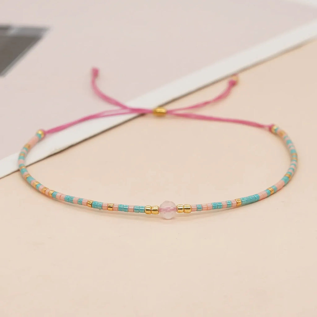 Handmade glass beaded bracelet with geometric design and semi-precious stone lucky bead charm