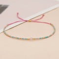 Handmade glass beaded bracelet with geometric design and semi-precious stone lucky bead charm