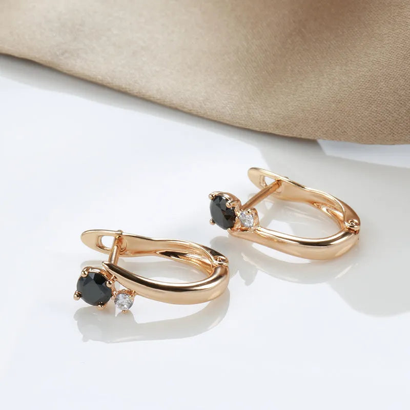 Gold drop-shaped earrings with geometric patterns and artificial gemstone inlay