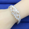 Gold electroplated copper fashion bracelet with zircon stones and ice flower design in multiple colours.