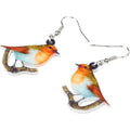 A pair of blue titmouse pendant earrings made from printed acrylic with a geometric, animal-inspired design.