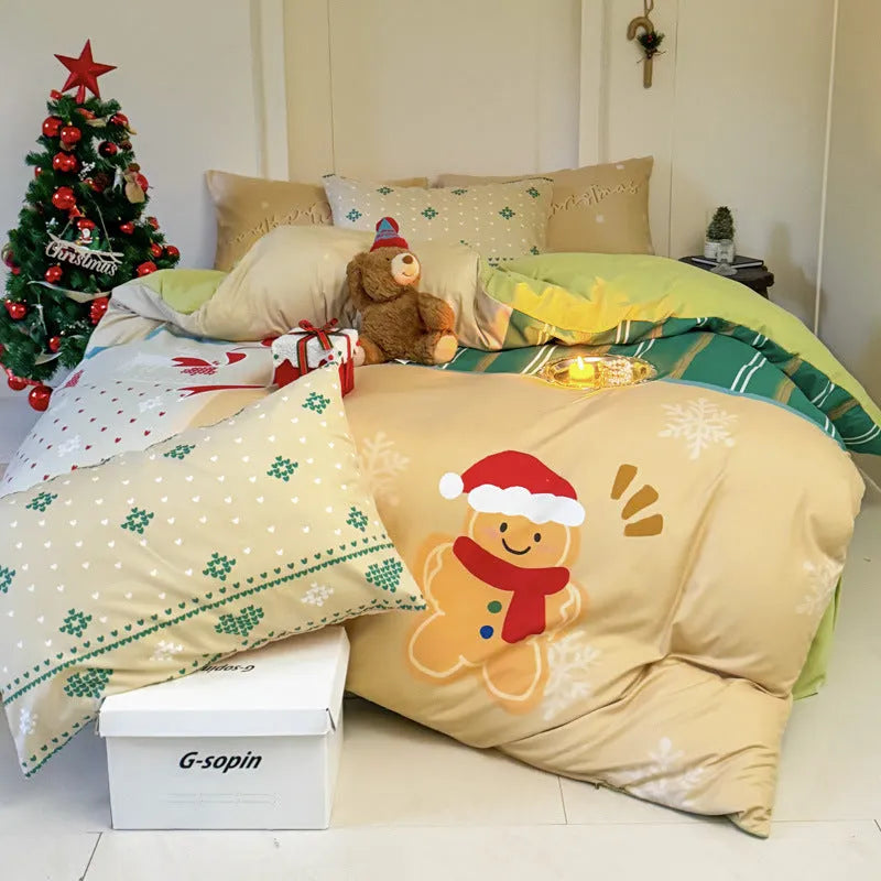 Christmas cartoon pattern four-piece bedding set with sheet, quilt cover, and two pillowcases on a bed.
