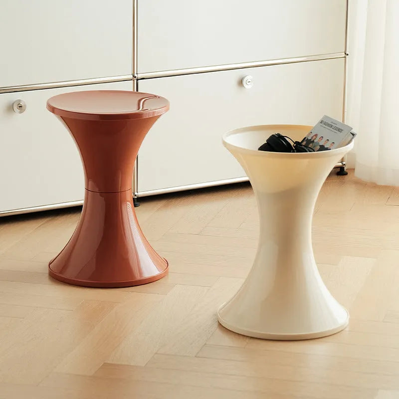 Plastic hourglass-shaped shoe changing stool shown in a selected colour.