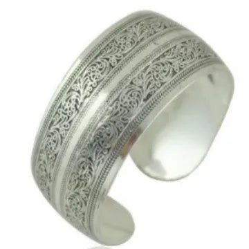Open cuff bracelet with carved ethnic Miao silver design in alloy material