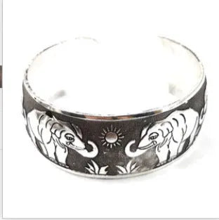 Open cuff bracelet with carved ethnic Miao silver design in alloy material