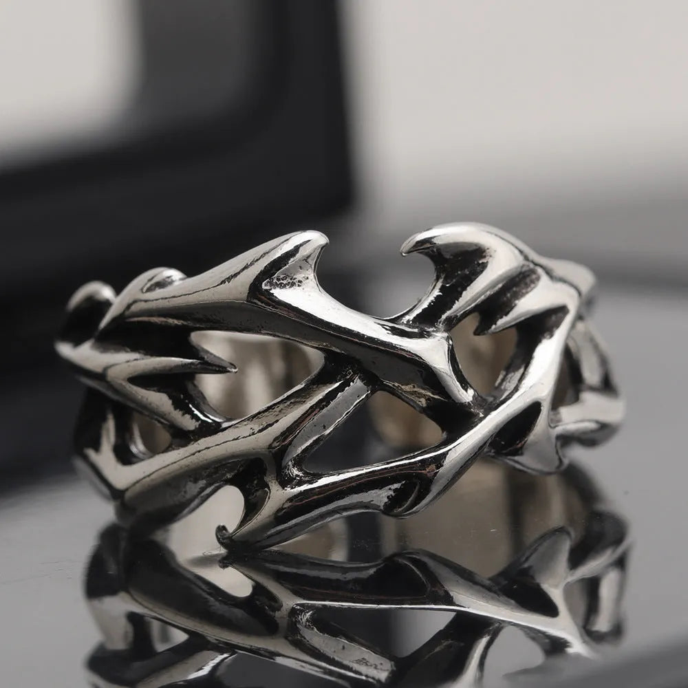 Copper men's ring with geometric thorn and flower design on an adjustable band.