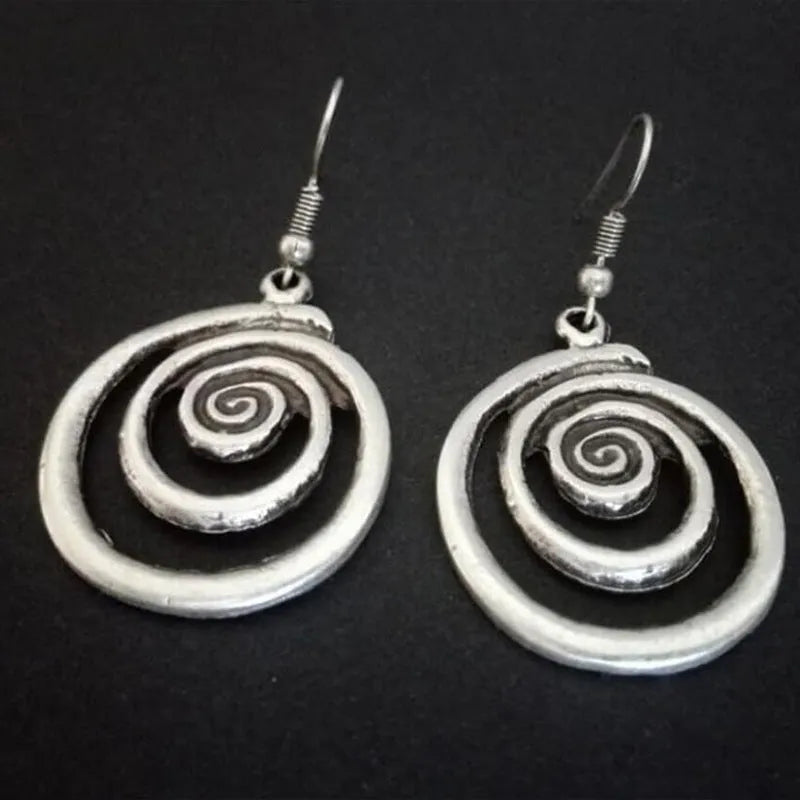 Silver geometric spiral distressed retro style earrings with a folk art design