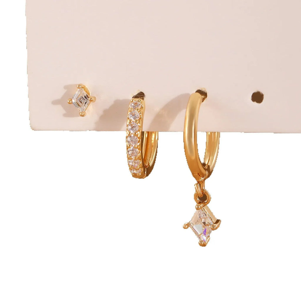 Women's three-piece geometric zircon earring set in gold showing pendant, stud, and clip-on styles