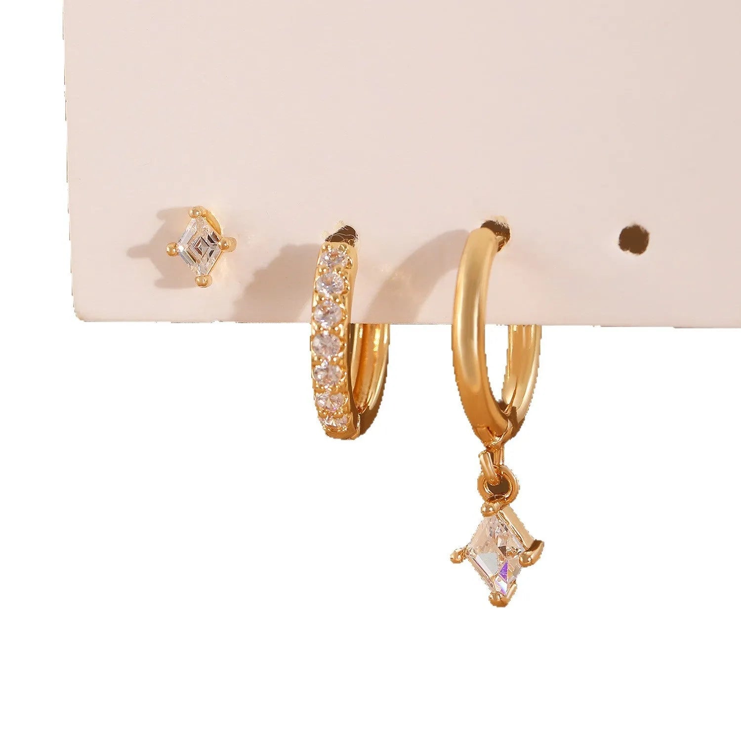 Women's three-piece geometric zircon earring set in gold showing pendant, stud, and clip-on styles