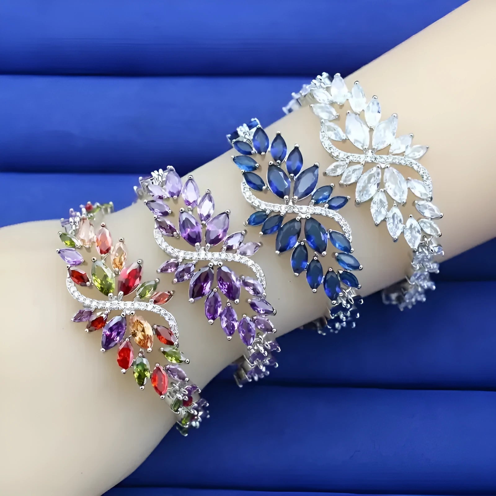 Gold electroplated copper fashion bracelet with zircon stones and ice flower design in multiple colours.