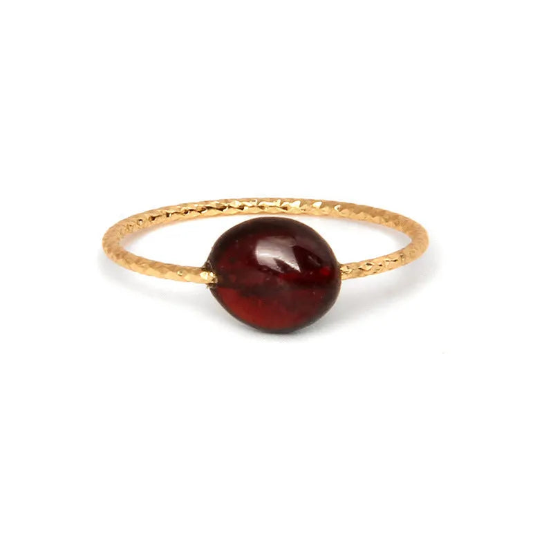 Close-up of a women's geometric agate ring showing its original design and coloured stone.