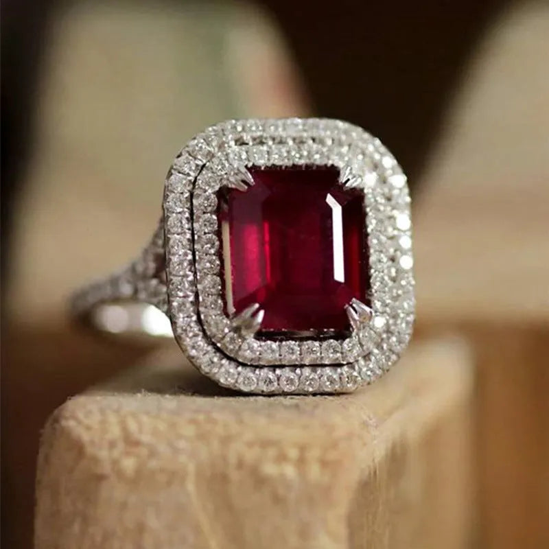 Copper geometric square ring with rhinestones in F827 red, shown on a finger.