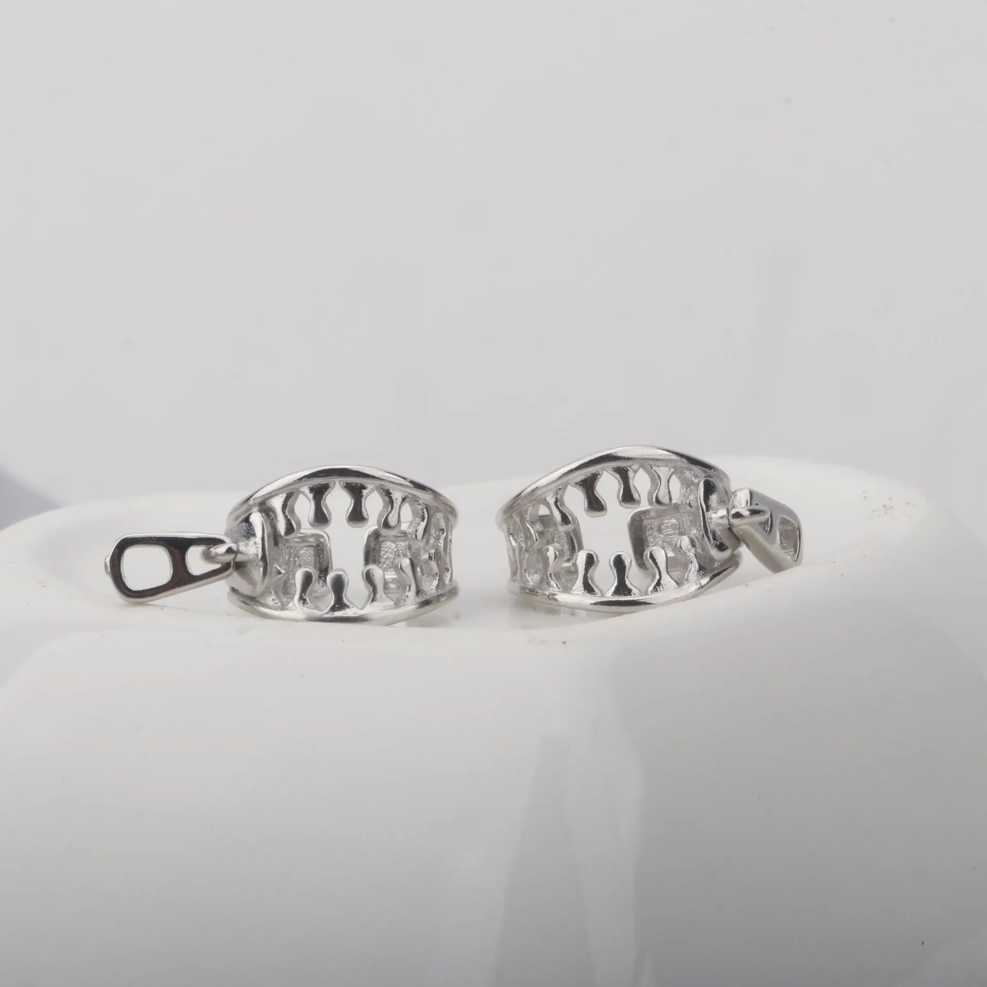 Geometric copper ear clips with zipper design showing 20-24mm bone shape