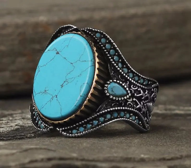 Men's turquoise alloy ring in antique silver colour showing round design and stone detail