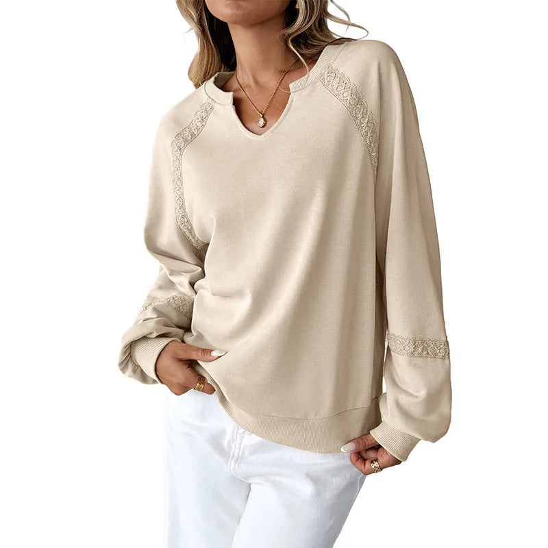 Women's loose fit sweater with lace-stitch half-open collar and long sleeves in a solid colour.