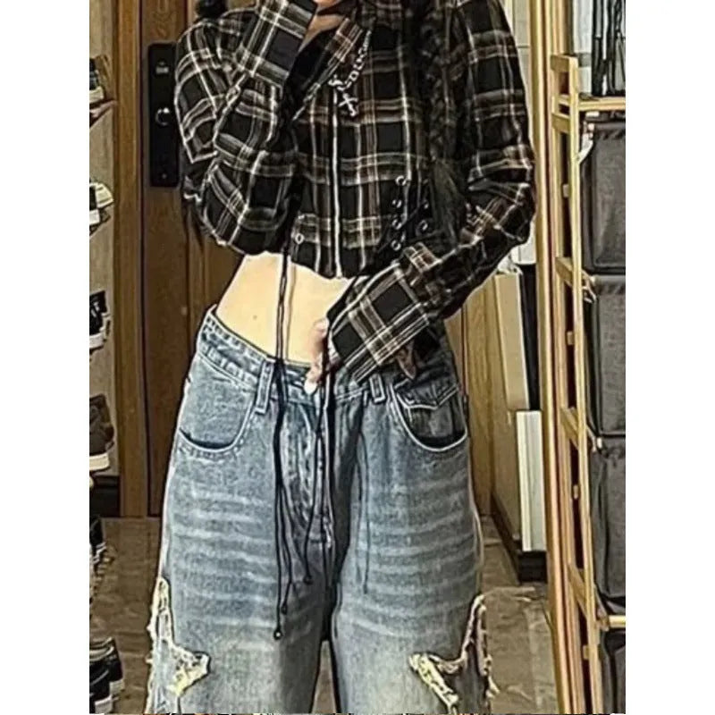 Blue high-waisted straight-leg women's jeans on a hanger.