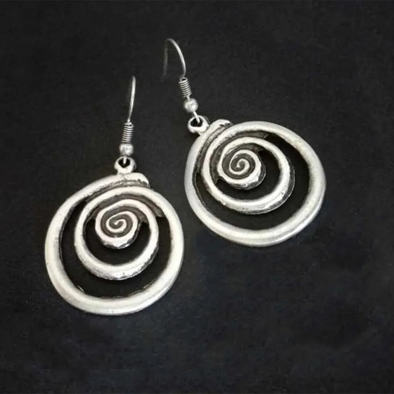 Silver geometric spiral distressed retro style earrings with a folk art design