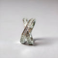 A silver or rose gold metal ring featuring a cross design with micro-inlaid zircon stones, shown in sizes 6 to 9.